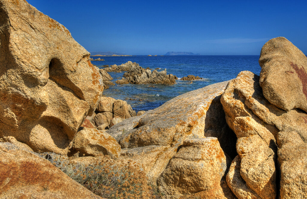Veduta dalla scogliera di Capo Comino con l' isola di Tavolara sullo sfondo.